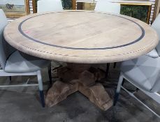 After the antique, a bleached walnut circular pedestal dining table, the top with inlaid and