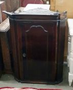Late Georgian walnut hanging corner cupboard with fluted sides and applied panel door, 70cm wide