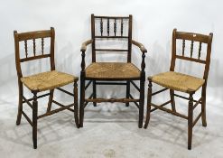 Hardwood spindle-back open arm elbow chair with rush seat and two matching single chairs (3)