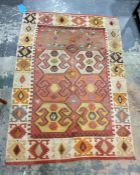 Eastern floor rug decorated with eight elephant foot guls, on a salmon pink ground to a hooked motif