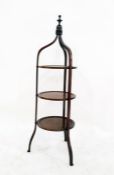 Three-tier mahogany and satinwood inlaid cake stand with turned finial uniting the three shaped