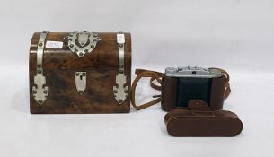 Burr walnut dome topped tea caddy, with white metal decorative bindings and embellishments