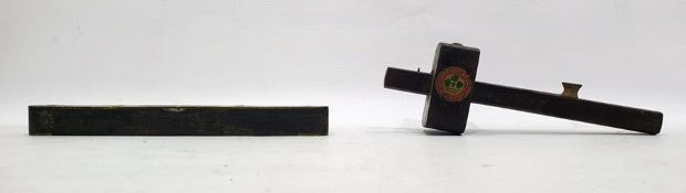 Wooden spirit level with brass mounts, 23cm long and a wooden mortice gauge with brass mounts, by