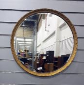 Circular bevelled wall mirror in gilt decorated frame  The mirror has a diameter of 53cm