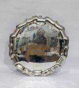 Early 20th century silver salver with inscription to centre, raised upon three feet, Sheffield 1921,