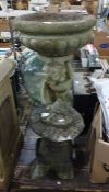Stone birdbath, cherub supporting bowl, and a stone Chinese style pagoda garden ornament
