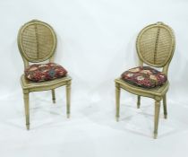 Pair of French style cane-back occasional chairs, the oval back with floral pediment, cane seat,