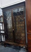 20th century Chippendale-style mahogany glazed bookcase, the top with blind fret carved frieze above