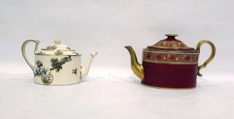 19th century porcelain teapot of oval form, the red body decorated with a gilt floral band and a