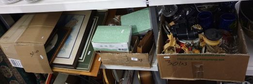 Three boxes of assorted household items to include pictures, thimbles, dragon candlestick holder,