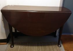 19th century mahogany swing-leg dining table on turned supports to pad feet