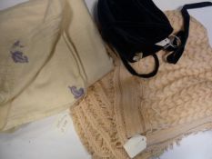 Pale pink cobweb baby's shawl, a wool blanket with embroidered corners and a black velvet child's