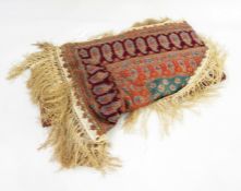 Early 20th century silk paisley shawl with one curved edge, bordered in orange, indigo and maroon,