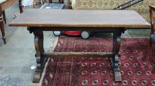 Early 20th century oak trestle table with rectangular top, the shaped end supports with stylised