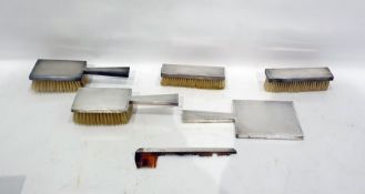 Six-piece silver-backed dressing table set, London 1948, comprising a pair of hairbrushes, a pair of