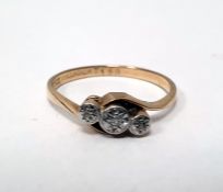 9ct gold and three-stone diamond ring, illusory set with tiny diamonds, in crossover