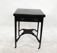 Mahogany envelope top rotating card table raised on square section tapering supports to brown