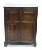 19th century oak two-door cupboard enclosing shelves, raised upon bracket feet, 72.5cm x 94.5cm