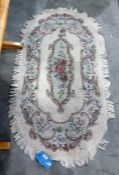 20th century cream ground rug with foliate spray to centre, 150cm x 82cm