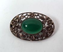 Silver and green hardstone brooch, set single polished oval stone, having openwork surround of