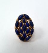 Gold cluster ring set with lapis lazuli (possibly Indian), the shoulders set with rubies (one