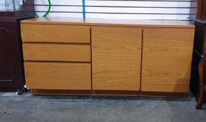 Mid 20th century teak sideboard with three drawers to the left hand side, two cupboard doors to