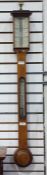 Victorian oak stick barometer, with twin 24 hour silvered pressure dials, temperature dial below,