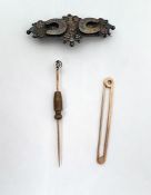 Gold-coloured tiepin of simple circular design set with a central cut diamond, unmarked, a plain