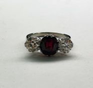 18ct gold ring set with central ruby (possibly heat treated) and two diamonds