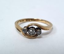 Early 20th century 18ct gold three-stone diamond ring in scroll setting, set one central and two