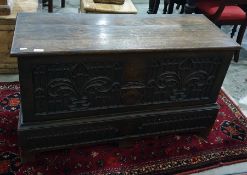 19th century oak coffer in the Gothic taste, with carved front panel, raised upon bracket