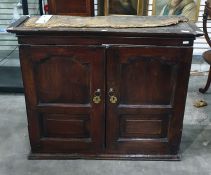 18th century oak two-door wall hanging cabinet, the ogee moulded cornice above two panelled doors