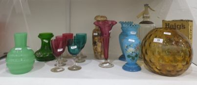 Large amber glass vase of dimpled globular form, an opaque green glass vase of ribbed bottle design,