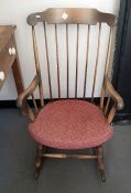 A modern rocking chair with stick back, and two rush seated country country chairs