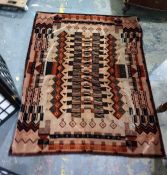 1970's rug in browns and oranges, 142cm x 117cm