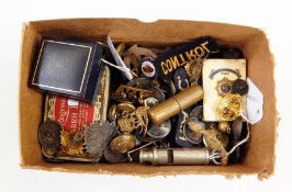 Collection of military cap badges and buttons