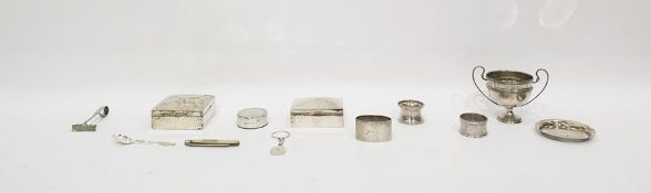 Silver two handled trophy, London 1907, three silver napkin rings, a silver cigarette box and