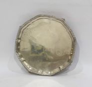 Silver salver, circular and plain with serpentine border, London 1944 on four tab feet, 20cm
