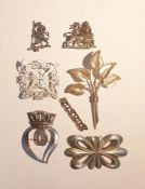 Iona silver brooch in the form of lion bearing flag pennant, a further silver and white metal brooch