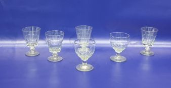 Six assorted 19th century rummers including a set of four tapering bowls, the lower half cut with