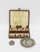 Silver sovereign case of circular hammered form, a small silver photograph frame of circular form