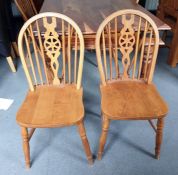 Four beech framed wheelback dining chairs and a cane-seated bedroom chair (5)