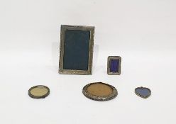 Silver photograph frame of rectangular form with harebell border, 16.5cm x 11cm, three further