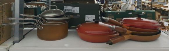 Le Creuset and other makes frying pans and a set of graduated lidded saucepans