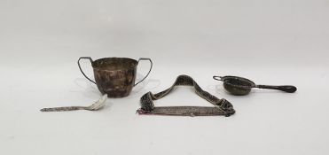 Silver two-handled sugar bowl, Birmingham 1933, of panelled form, a silver tea strainer with