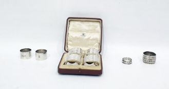 Set of four silver napkin rings by Mappin & Webb, Chester 1919, each of oval form with engine-turned