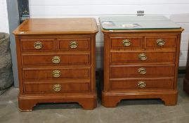 Pair of 20th century yew bedside chests, the rectangular tops with canted corners, above two short