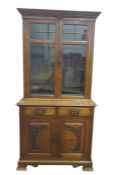 20th century oak bookcase cabinet, the glazed doors enclosing adjustable shelves above two drawers