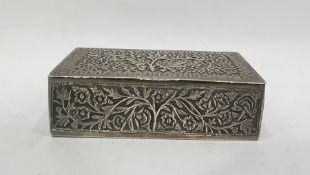 Indian white metal box of rectangular form, the hinged cover decorated with flowers in a leaf