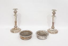 Pair of silver plated candlesticks with baluster stems and circular feet and a pair of silver plated